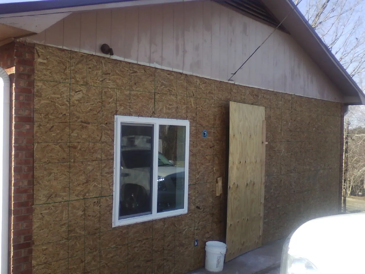 OSB sheathing on a garage addition wall before siding in Shermans Dale