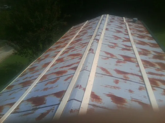 Rusted metal roof panels with new wood purlins before replacement — Storm Damage Roof Repair in Shermans Dale by Roofing Brothers
