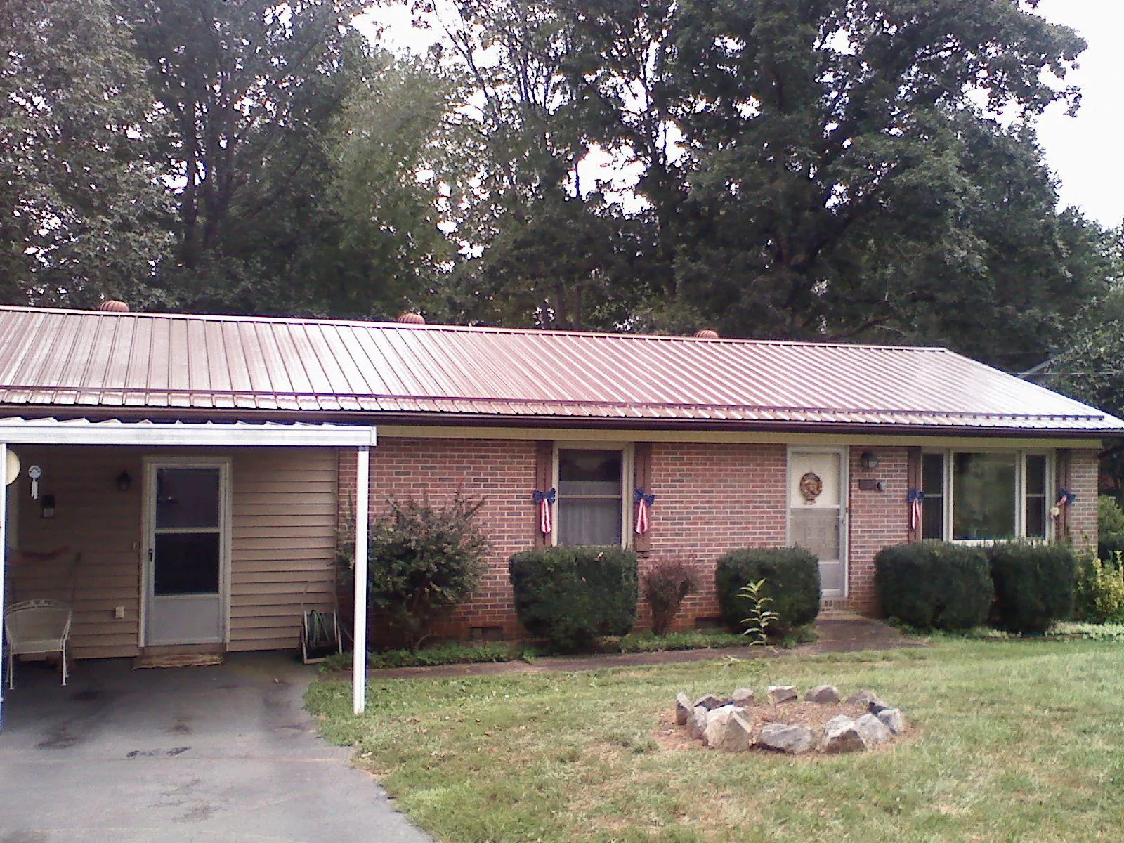 Bronze metal roof and carport on a brick ranch home — Roof Repair work by our crew in Shermans Dale
